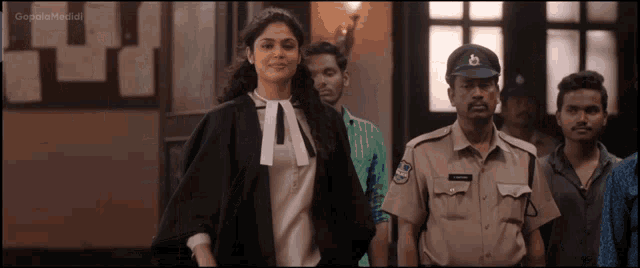 a woman in a gown is standing next to a man in a police uniform