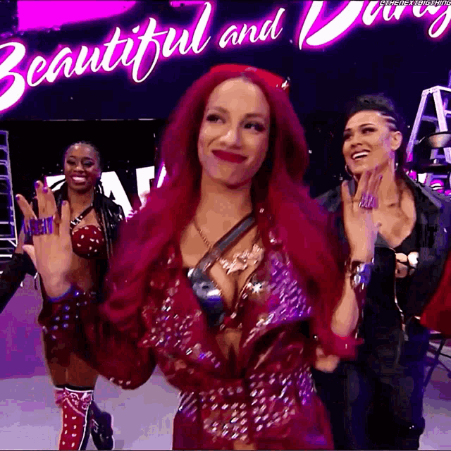 a woman with red hair is standing in front of a beautiful and daring sign