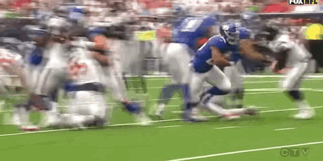 a football game is being played on a field with a lot of players on it .