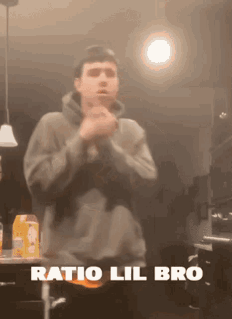 a man standing in a kitchen with the words ratio lil bro written above him