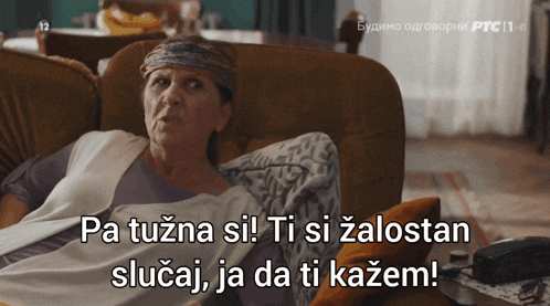 a woman laying on a couch with the words pa tuzna si ti si zalostan slučaj ja da ti kazem