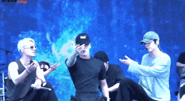 a man wearing a black hat with the word bad on it is dancing on stage