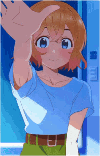 the girl is wearing a blue shirt and green shorts and is reaching out her hand towards someone .