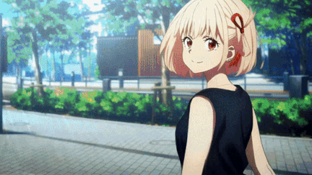 a girl with blonde hair and red eyes is wearing a black top