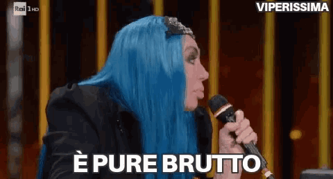 a woman with blue hair is holding a microphone and saying pure brutto .