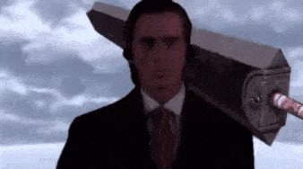 a man in a suit and tie is holding a giant sword on his shoulder .