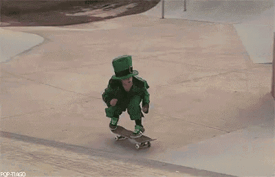 a person in a green leprechaun costume is riding a skateboard on a ramp .