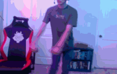 a blurry picture of a person holding hands in front of a chair that says g2