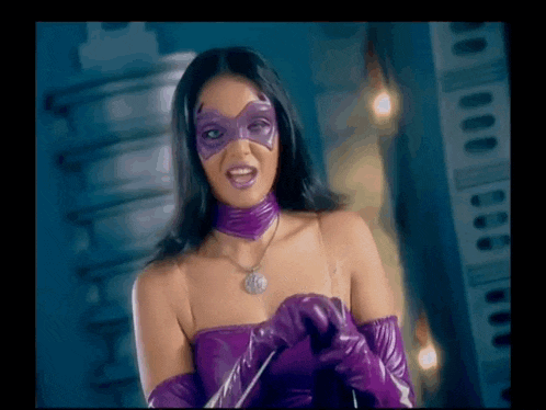 a woman wearing a purple mask and gloves is standing in front of a building