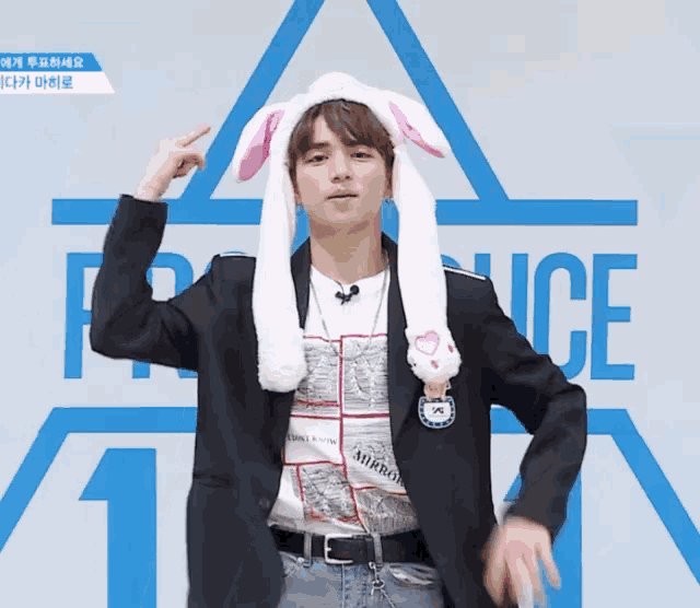 a man wearing bunny ears stands in front of a sign that says ice