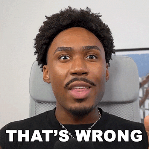 a man sitting in a chair with the words that 's wrong written on his face