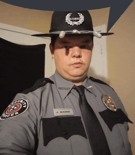 a security guard named j. baird poses for a photo