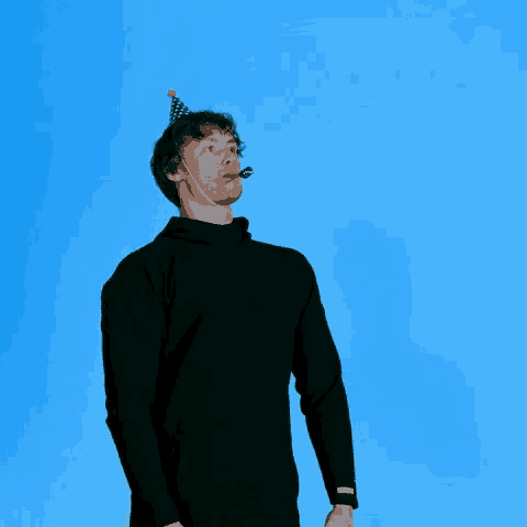 a man wearing a party hat and a microphone looks up at the sky