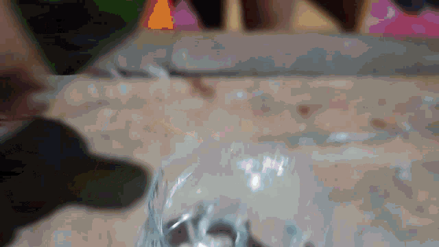 a blurred image of a person 's hand holding a bottle