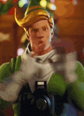 a man dressed as an elf is holding a camera in front of a christmas tree