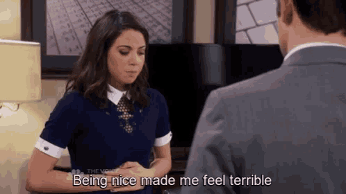 a woman is talking to a man in a suit and says being nice made me feel terrible