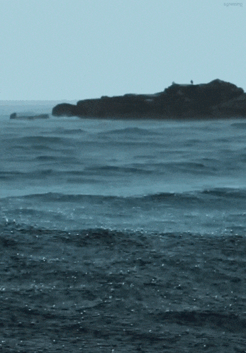 a large body of water with waves crashing on the shore