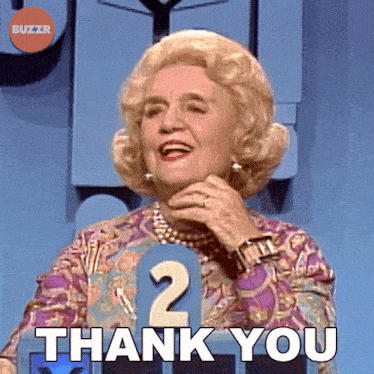 a woman is holding her hand to her chin and says " thank you "