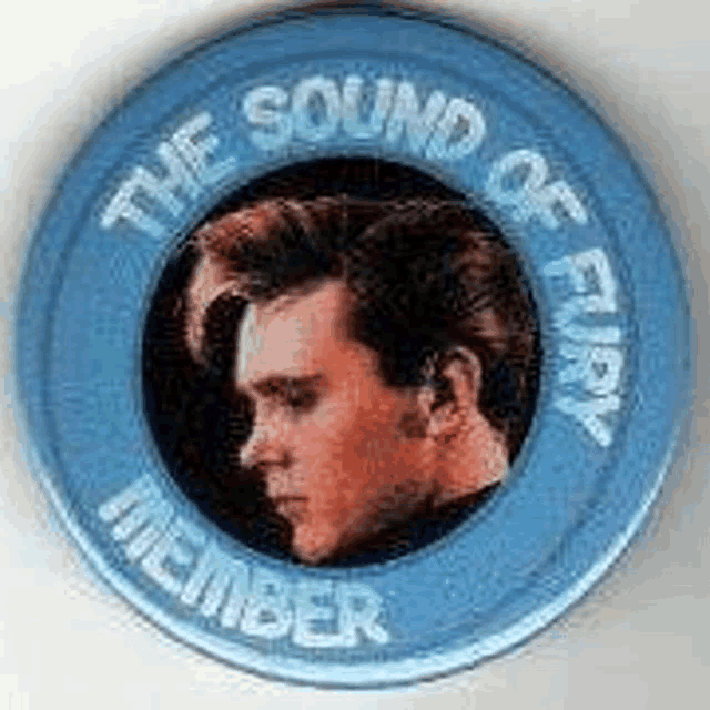 a blue button with a picture of a man in a circle that says the sound of every member .