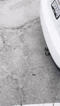 a white car with a california license plate that says 77er13x