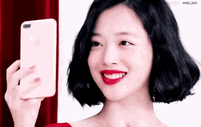 a woman is smiling while taking a picture with her phone