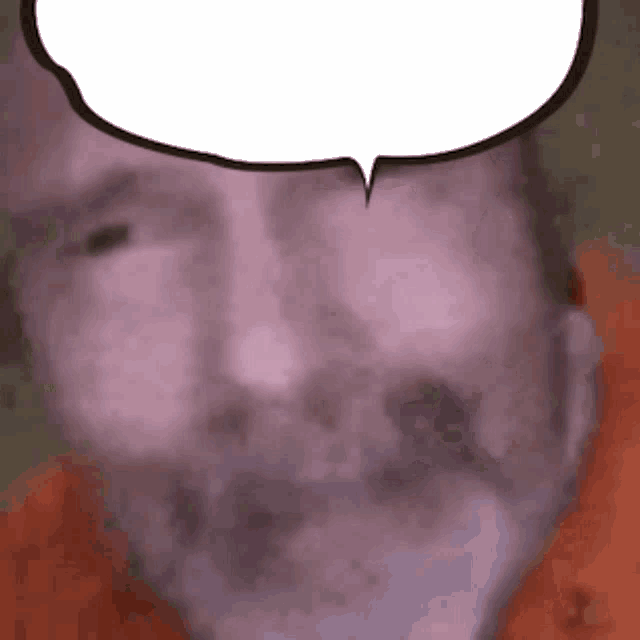 a close up of a man 's face with a speech bubble above his head