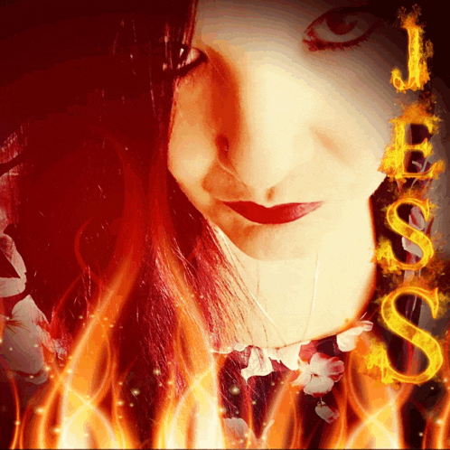 a woman 's face is surrounded by flames and the letters jesus are visible