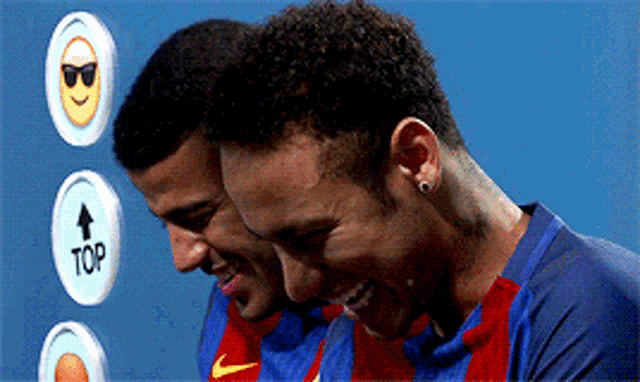 two soccer players are standing next to each other with a sign that says top in the background