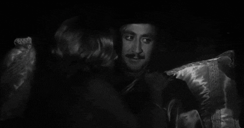 a close up of a man 's face with a woman behind him