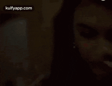 a close up of a woman 's face with a bindi on her forehead .