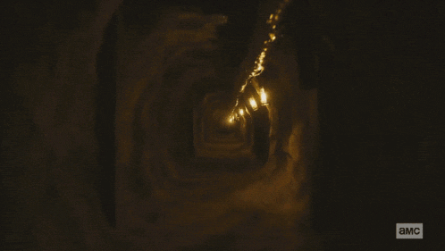 a blurred image of a person in a dark room with the letters a.m.c. on the bottom