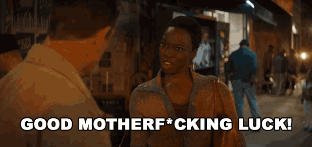 a woman talking to a man with the words good motherf * cking luck