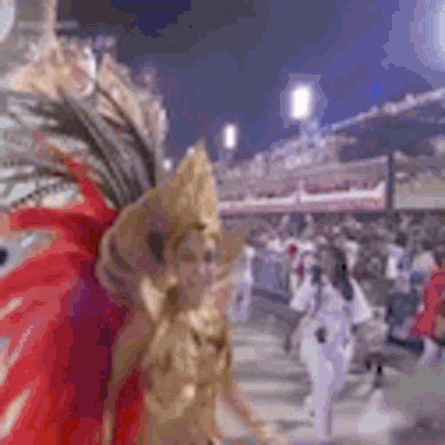 a woman in a gold and red costume is walking down a street at a carnival .