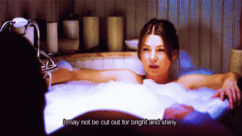 a woman laying in a bathtub with the words " i may not be cut out for bright and shiny "
