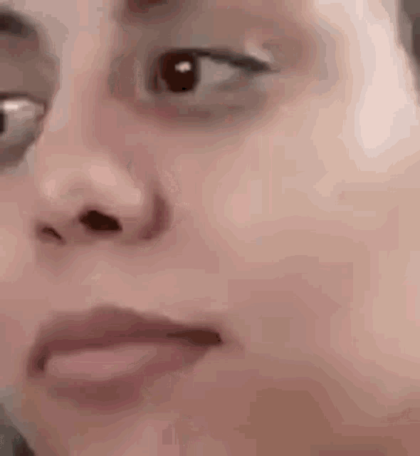 a close up of a person 's face with their eyes closed and their mouth open .