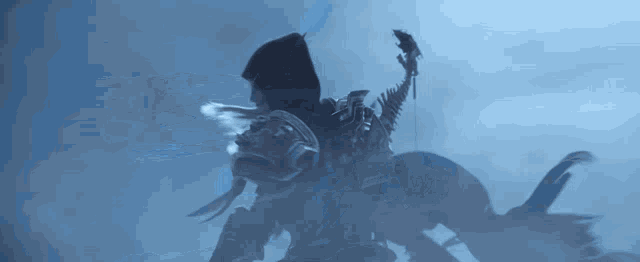a silhouette of a person riding a monster in a foggy sky