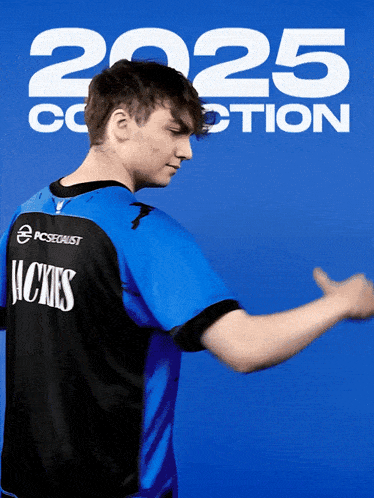 a man wearing a blue shirt with the word hicks on the back