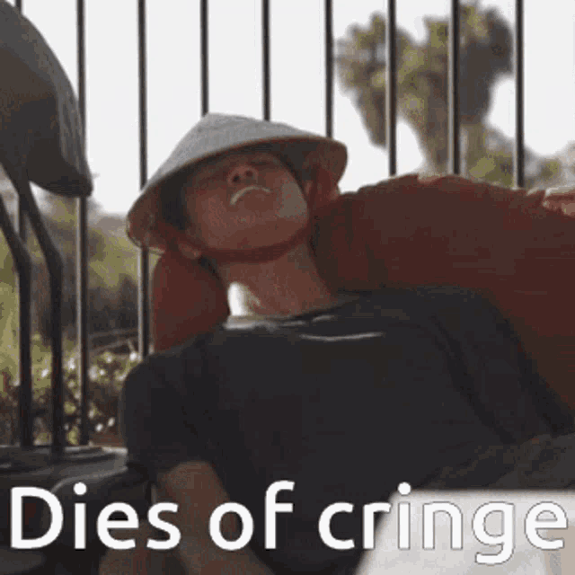 a man wearing a conical hat is laying down with the words dies of cringe written below him