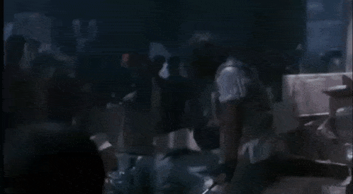 a person is standing next to a box that says jvc on it in the dark .