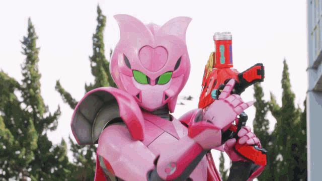 a pink robot is holding a red gun