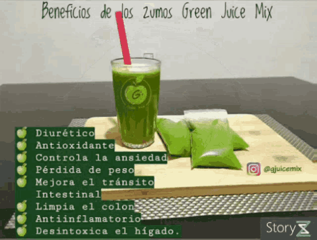 a glass of green juice with a red straw on a table