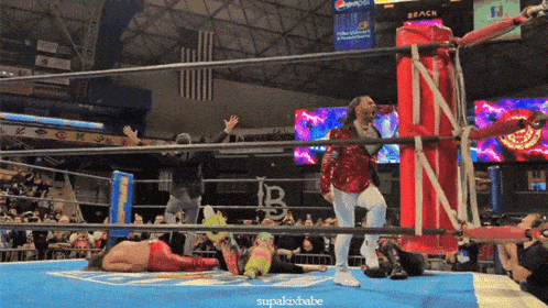 a wrestling ring with a pepsi sign on the wall above it