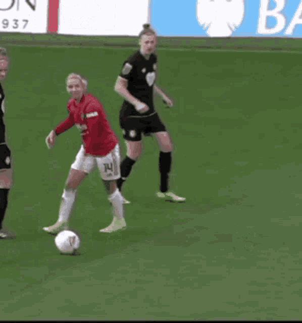 a soccer player wearing a red shirt with the number 24 on it