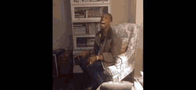 a man sits in a chair smoking a cigarette