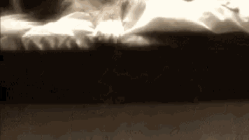 a person is laying on a bed with white sheets and a black mattress .