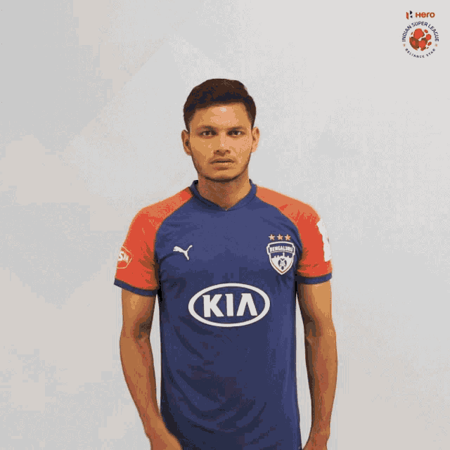 a man in a blue and red kia jersey