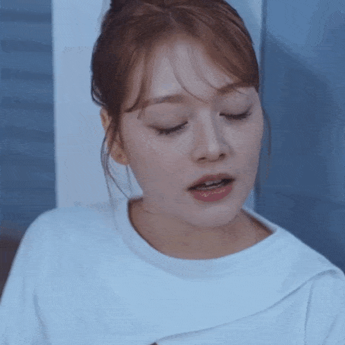 a close up of a woman 's face with her eyes closed and her mouth open