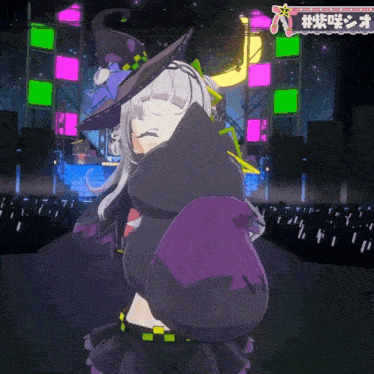 a girl in a witch costume is standing in front of a stage