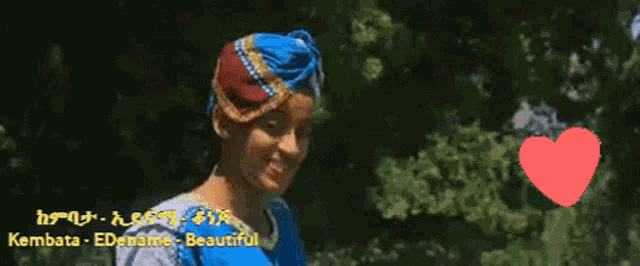 a woman wearing a turban and a blue shirt with the words i love you on the bottom