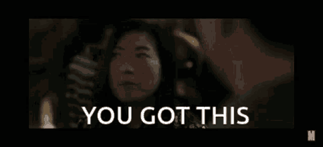 a man and a woman are looking at each other and the words `` you got this '' are written on the screen .